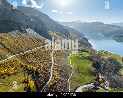 Drone shot of scenic mountain range and wide lake under sun rays in Southern France. Stock Photo