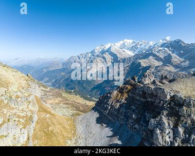 Aerial view of mountain range and ice mountain featuring in the background under clear sky in the Southern France. Stock Photo