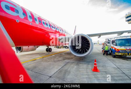 November 17 2022- Bangkok Thailand- Domestic flights with planes painted red and the sunrise in the background Stock Photo