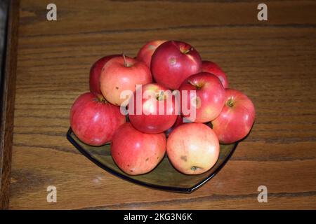 apples on a blue glass plate Stock Photo
