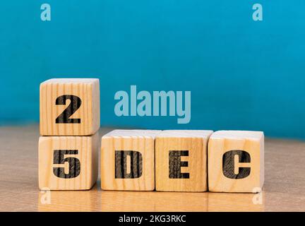 Cube shape calendar for December 25 on wooden surface with empty space for text,cube calendar for december on wood background Stock Photo