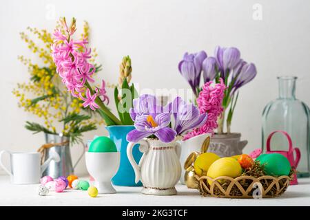 Spring flowers in pot and pitcher Easter background Stock Photo