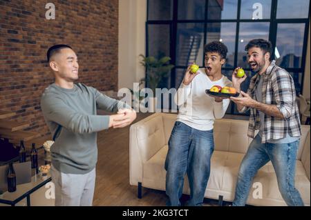 Friendly host entertaining his guests at home Stock Photo