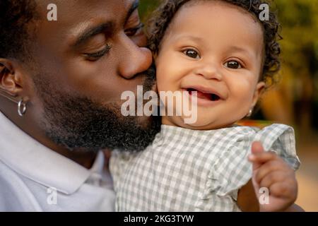 Loving dad giving a kiss to his petty child Stock Photo