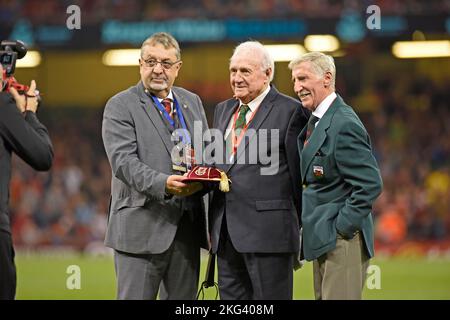 Terry Medwin (Middle) and Cliff Jones (right) who were both members of Wales’ 1958 World Cup squad.  Stock picture from 11th October 2018 taken ahead of the  International friendly between Wales and Spain at the National Stadium of Wales in Cardiff. Wales' Terry Medwin (Centre) is presented with a golden cap by FAW President Kieran O'Connor (L) alongside Cliff Jones (R) during the International Friendly match between Wales and Spain at the Principality Stadium. Stock Photo