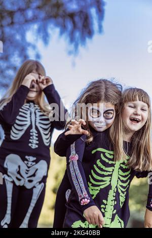 Children celebrating a Halloween costume party in the back garden Stock Photo