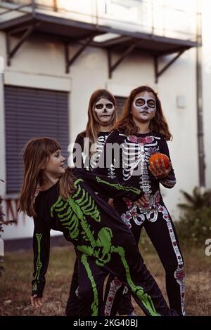 Children celebrating a Halloween costume party in the back garden Stock Photo