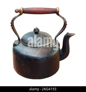 Old worn brown teapot with wooden handle. Stock Photo