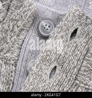 Neck of wool grey knitted button sweater Stock Photo
