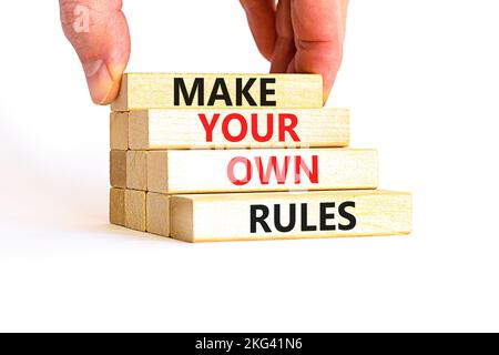 Make your own rules symbol. Concept words Make your own rules on wooden cubes. Beautiful white table white background. Businessman hand. Business moti Stock Photo