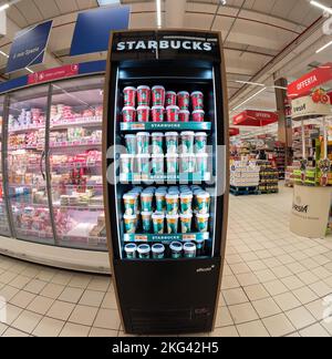 Cuneo, Italy - November 18, 2022: Starbucks products in shop window refrigerator with coffee and milk and cappuccino and caramel cardboard cups in ita Stock Photo