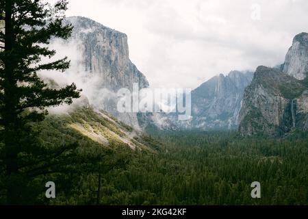 Sun shining through clouds in Yosemite Valley Stock Photo
