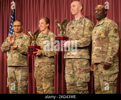 U.S. Army 1st Lt. Molly Murphy, a pediatric nurse at Tripler Army Medical Center in Honolulu, Hi., and Army Capt. Christopher Wunsch, a dentist with DENTAC-Japan, hold their winner's trophies alongside Col. Edgar G. Arroyo and Command Sgt. Maj. Fergus J. Joseph at the awards ceremony for Medical Readiness Command, Pacific's Fiscal Year 2023 Best Medic Competition, Oct. 28, 2022 at Joint Base Lewis-McChord, Wash. Eight top Soldiers from across MRC,P competed in ten events over three days including a 15-mile ruck march, water survival tests, marksmanship, combat casualty care, and more. Stock Photo