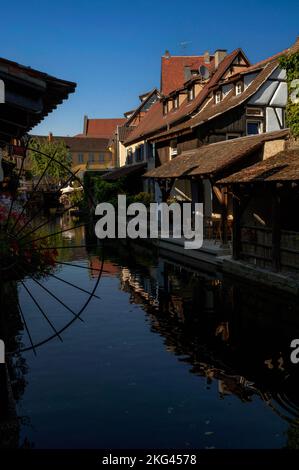 Historic Little Venice (La Petite Venise) at Colmar, Alsace, Grand Est, France, blends spectacular timber-framed houses and hotels with waterside restaurants along the canalised River Lauch, which is busy in the tourist season with flat-bottomed boats carrying visitors on guided tours. Stock Photo