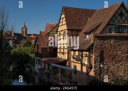 The Caveau Saint-Pierre restaurant, in a large 16th century typically Alsatian timber-framed house, offers waterfront dining beside the River Lauch in the picturesque Little Venice (La Petite Venise) area at Colmar, Alsace, Grand Est, France. Stock Photo