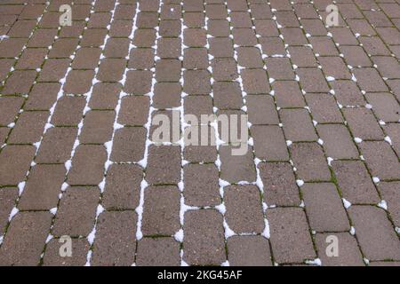 View of paving from paving slabs near house on winter day. Sweden. Stock Photo