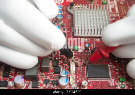 mechanic repairing motherboard, motherboard top view close-up, computer motherboard Stock Photo