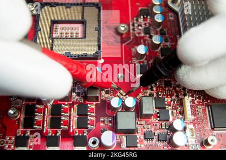 mechanic repairing motherboard, motherboard top view close-up, computer motherboard Stock Photo