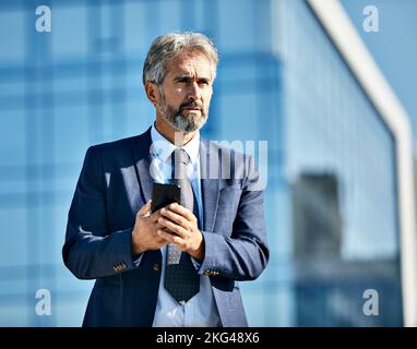 businessman building business outdoor man senior mobile phone smartphone communication phone elderly messaging texting Stock Photo