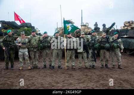 Commanders from various nations stand in front of M1A2 Abram tanks for a group photo after the closing ceremony of Exercise Iron Wolf 22 at Pabradė Training Area, Lithuania, Oct. 28, 2022. The 3-4 ABCT is among other units assigned to the 1st Infantry Division, proudly working alongside NATO Allie’s and regional security partners to provide combat-credible forces to V Corps, America’s forward deployed corps in Europe. Stock Photo