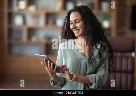 Portrait of smart young entrepreneur woman using her digital tablet Stock Photo