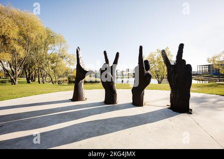 Lviv, Ukraine - October 09, 2022: Metal sculpture of four hands. Looking at their gestures read the letters LVIV. Stock Photo