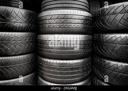Stacks of old tires put together in the automobile tyre shop Stock Photo