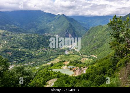 Tskhenistsqali river valley landscape in Racha region of Georgia with Svaneti mountain range, lush green forests and vineyards seen from to Khvamli Stock Photo