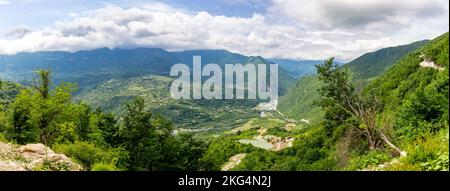 Tskhenistsqali river valley panorama in Racha region of Georgia with Svaneti mountain range, lush green forests and vineyards seen from to Khvamli Stock Photo