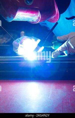 closeup portrait of a workman welding metal in fabrication workshop Stock Photo