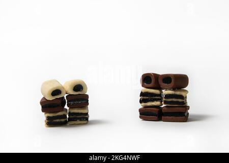 Piles of black and white licorice candies on white background Stock Photo
