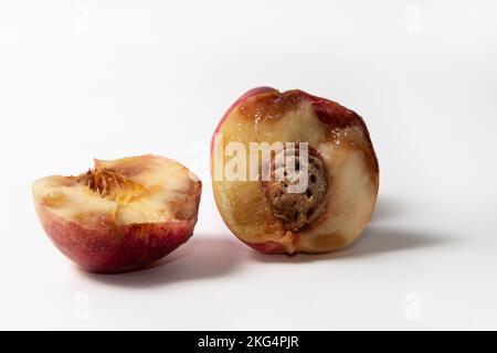 Halves of an overripe nectarine Stock Photo