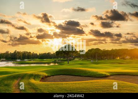 Panorama Golf course with a sand bunker in the center. Dramatic clouds in the sky during sunset Belek Turkey Stock Photo