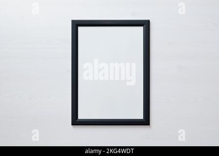 Black picture frame on white wall. Blank picture for art painting and photo hanging mockup Stock Photo