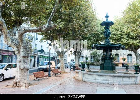 Fountain,on,square,behind, Mairie de Meze,Town Hall,of,Meze,Herault,South of France,France,French,harbour,harbor,port,marina,August,summer,mediterannean,mediterranean,Occitanie,Europe,European,