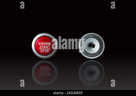 Modern engine start stop button and old style metal keyhole comparison, objects isolated with reflection on the floor on black background Stock Photo