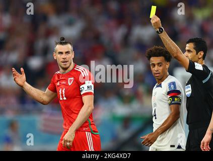 Ar Rayyan, Qatar. Ar Rayyan, Qatar. 21st Nov, 2022. Soccer: World Cup, USA - Wales, preliminary round, Group B, Matchday 1, Ahmed bin Ali Stadium, referee Abdulrahman Ibrahim Al-Jassim (r) shows Gareth Bale (l) of Wales the yellow card. In the middle, Tyler Adams of the USA goes off. Credit: Tom Weller/dpa/Alamy Live News Credit: dpa picture alliance/Alamy Live News Stock Photo