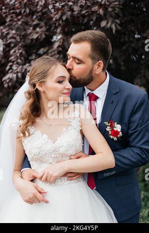 portrait of young bride and groom enjoying romantic moments outside Stock Photo