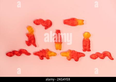Yellow and red gummy candies on pink background Stock Photo