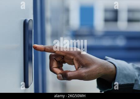 Side view closeup of male hand entering key code on door for storage unit, copy space Stock Photo