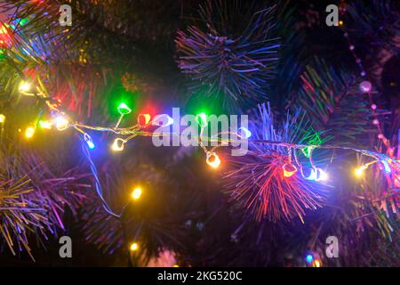 Closeup of Christmas tree decorations. Lights on Christmas tree. Christmas and New Year decorations on Christmas tree. Christmas tree with decorations Stock Photo