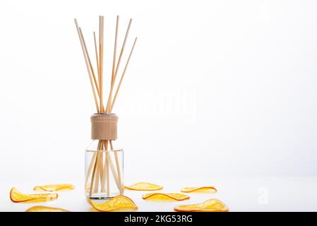 Reed diffuser and different citrus fruits on table. Stock Photo