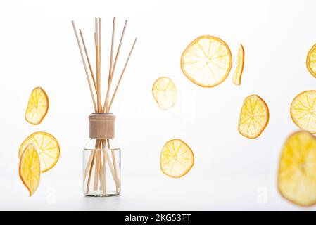 Reed diffuser and different citrus fruits on table. Stock Photo