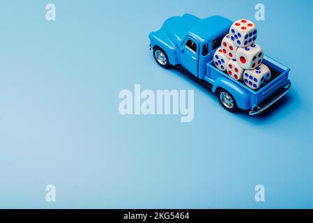 A car with cubes with numbers on a blue background. Game concept. Stock Photo