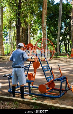 Old man exercising with outdoor fitness equipment at Parque Rosinha Cadar in Belo Horizonte, Brazil. Stock Photo
