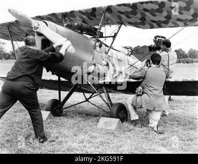 GEORGE PEPPARD poses in cockpit of Biplane for still photographer and for Movie Cameraman during filming on location in Ireland of THE BLUE MAX 1966 director JOHN GUILLERMIN novel Jack Hunter music Jerry Goldsmith Twentieth Century Fox Stock Photo