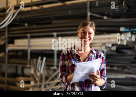 Joyful woman inspecting warehouse Stock Photo
