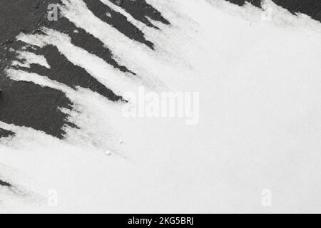 Ripped up pieces of white paper arranged on black background Stock Photo