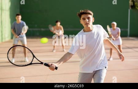 Young man playing frontenis on outdoor pelota court Stock Photo