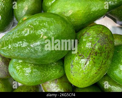 Avocado are very nutritious, contains variety of nutrients, green avocado on the table, background, central American, avocado from Mexico, closeup Stock Photo